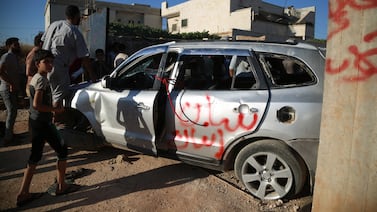 Protestors stand near a damaged car at a Turkish Military base check point during a protest against Turkey, in Atarib city, near Aleppo, Syria, 01 July 2024.  Multiple protests in Turkey's controlled area in Northern Syria were held by Syrian protestors following riots between Syrian refugees and Turkish protestors in Kayseri city.  Following claims of a child being sexually assaulted, violent protests targeted the Kayseri refugee community in Turkey.  Numerous people have been placed under arrest in the wake of the incidents.  Counterprotests in the areas of northern Syria under Turkish authority were sparked by the events.  The Turkish Ministry of Foreign Affairs stated that 'it was wrong to use the sad events that took place in Kayseri after the crime, for which a judicial process was carried out against the suspect, as a material for provocations beyond the borders of Turkey'.   EPA / BILAL AL HAMMOUD