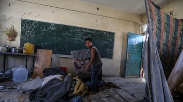 An internally displaced Palestinian boy inspects his family's shelter at a UNRWA-run school, a school-turned-shelter known as al-Jaouni, following an Israeli air strike in Al-Nuseirat refugee camp, central Gaza Strip, 11 September 2024.  According to the Palestinian Ministry of Health in Gaza, at least 18 Palestinians have been killed and dozens injured following Israeli air strikes.  The Israeli military stated that it conducted a 'precise strike' on militants operating inside a Hamas command and control center in the area of Nuseirat in central Gaza.  More than 40,000 Palestinians and over 1,400 Israelis have been killed, according to the Palestinian Health Ministry and the Israel Defense Forces (IDF), since Hamas militants launched an attack against Israel from the Gaza Strip on 07 October 2023, and the Israeli operations in Gaza and the West Bank which followed it.   EPA / MOHAMMED SABER