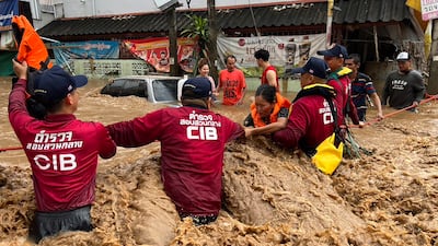Members of Thailand's Central Investigation Bureau help flood victims in the northern province of Chiang Rai, where Typhoon Yagi triggered flash flooding and landslides. EPA