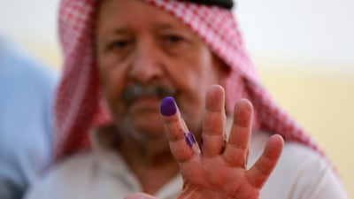 A Jordanian shows his ink-stained finger after casting his vote in parliamentary elections at a polling station in Al Salt near the capital Amman on September 10. AFP