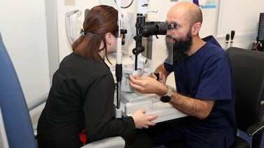 An optometrist examines a patient at the Moorfields eye hospital in Abu Dhabi. Cash-rich investment funds in the GCC are looking to life sciences, pharmaceutical and healthcare assets in the UK, the US and Europe. Pawan Singh / The National