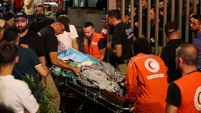 A stretcher bearing an injured person is taken to American University of Beirut Medical Centre. Reuters