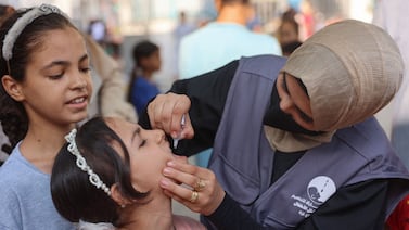 A medic administers polio vaccines to children at the Al Darraj neighbourhood clinic in Gaza city on September 10 while war between Israel and Hamas claims thousands of non-combatant lives. AFP