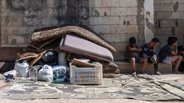 Children of an evicted Syrian family sit outside their former home with their belongings on June 25, 2024. Syrian refugee families are increasingly facing eviction as some municipalities are 'cracking down' on families who are residing in Lebanon without legal residency permits. (Matt Kynaston / The National)