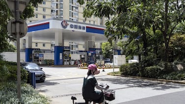 A CNOOC petrol station in Shanghai. Oil demand remains tepid in China, dragging global demand forecasts down. Bloomberg