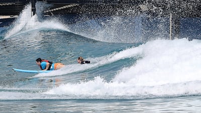 Writer Evelyn Lau learns to surf with guide Gabi Lailvaux. Pawan Singh / The National