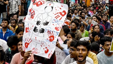 Junior doctors hold posters during a protest to demand the resignation of a city police commissioner and condemn the rape and murder of a medic, in Kolkata on September 2, 2024. AFP