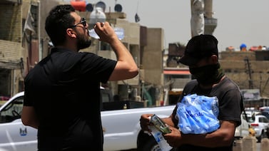 An Iraqi street vendor sells cold water on a sweltering hot day in central Baghdad. EPA
