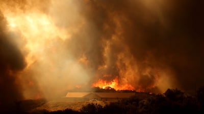 A mountainside is engulfed in flames as the Airport Fire gains ground near Lake Elsinore, California. AFP