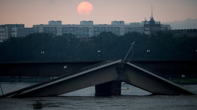 The sun rises over the partially collapsed Carola Bridge on the Elbe river in Dresden, Germany. Reuters