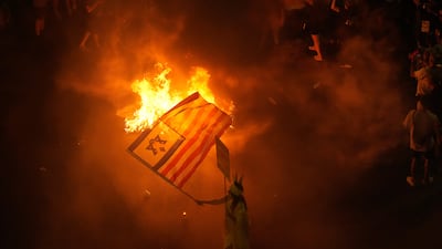 A demonstrator waves an Israeli-US flag at a protest against Prime Minister Benjamin Netanyahu's government in Tel Aviv. 
 AP