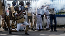 Police fire tear gas to disperse anti-state government protesters in Kolkata, eastern India. AP