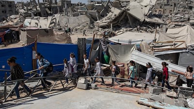 Palestinian children head for lessons in the Khan Younis camp, southern Gaza, in a makeshift classroom set up by teacher Israa Abu Mustafa in a tent in the rubble of her old house.  EPA