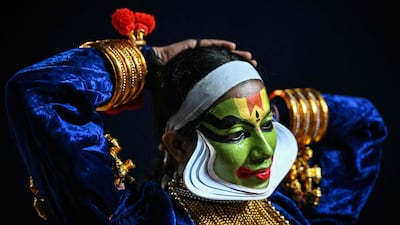 An entertainer prepares to perform Kathakali, a traditional form of classical Indian dance, at a cultural festival in Chennai.  AFP